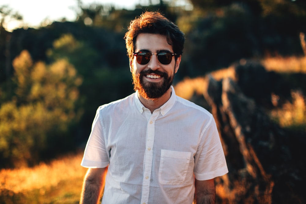 smiling man standing in field