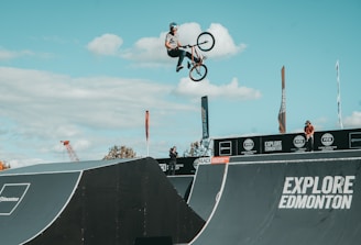 Young BMX riders practicing on the Big Bear Valley track under a sunny sky.
