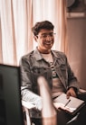 smiling man sitting on chair inside room