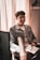 smiling man sitting on chair inside room