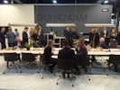 A group of entrepreneurs sharing ideas during a workshop in a modern event space.