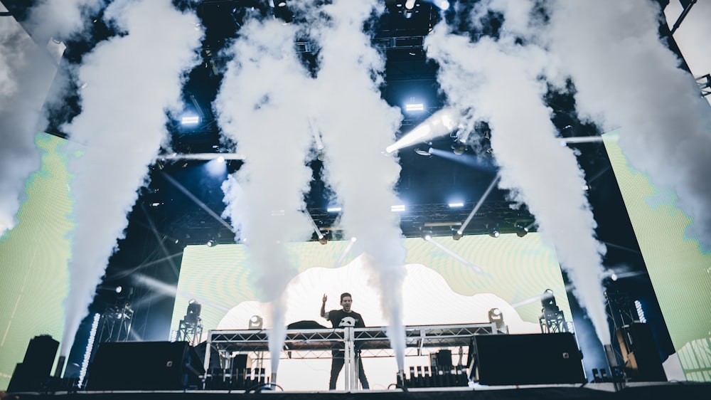 man standing in front of stage to perform