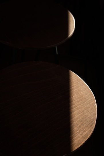 Elegant epoxy resin tabletops shining under warm ambient light.