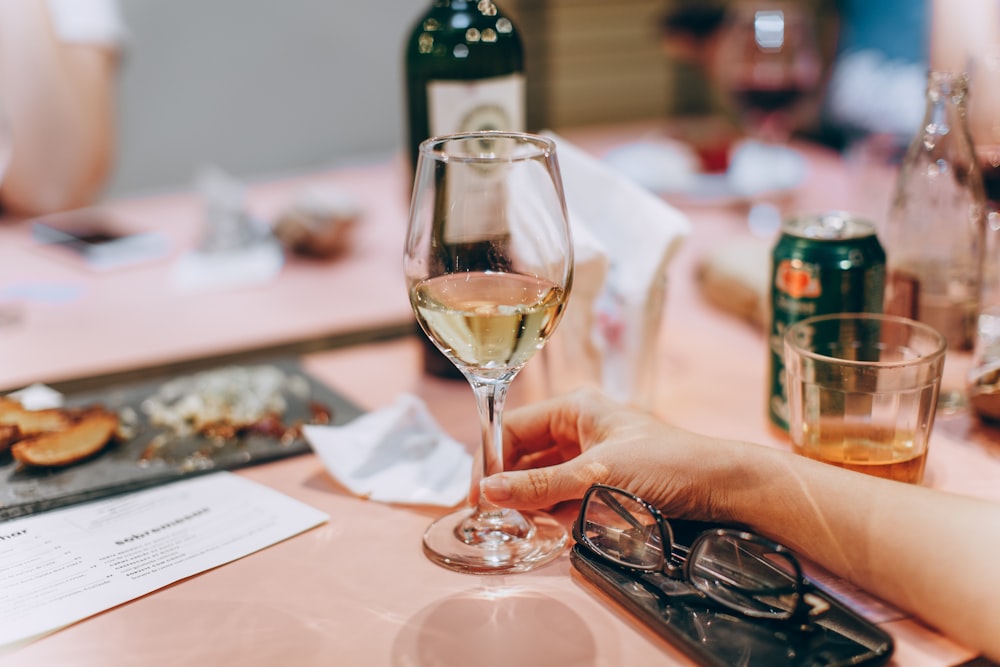 person holding glass of wine