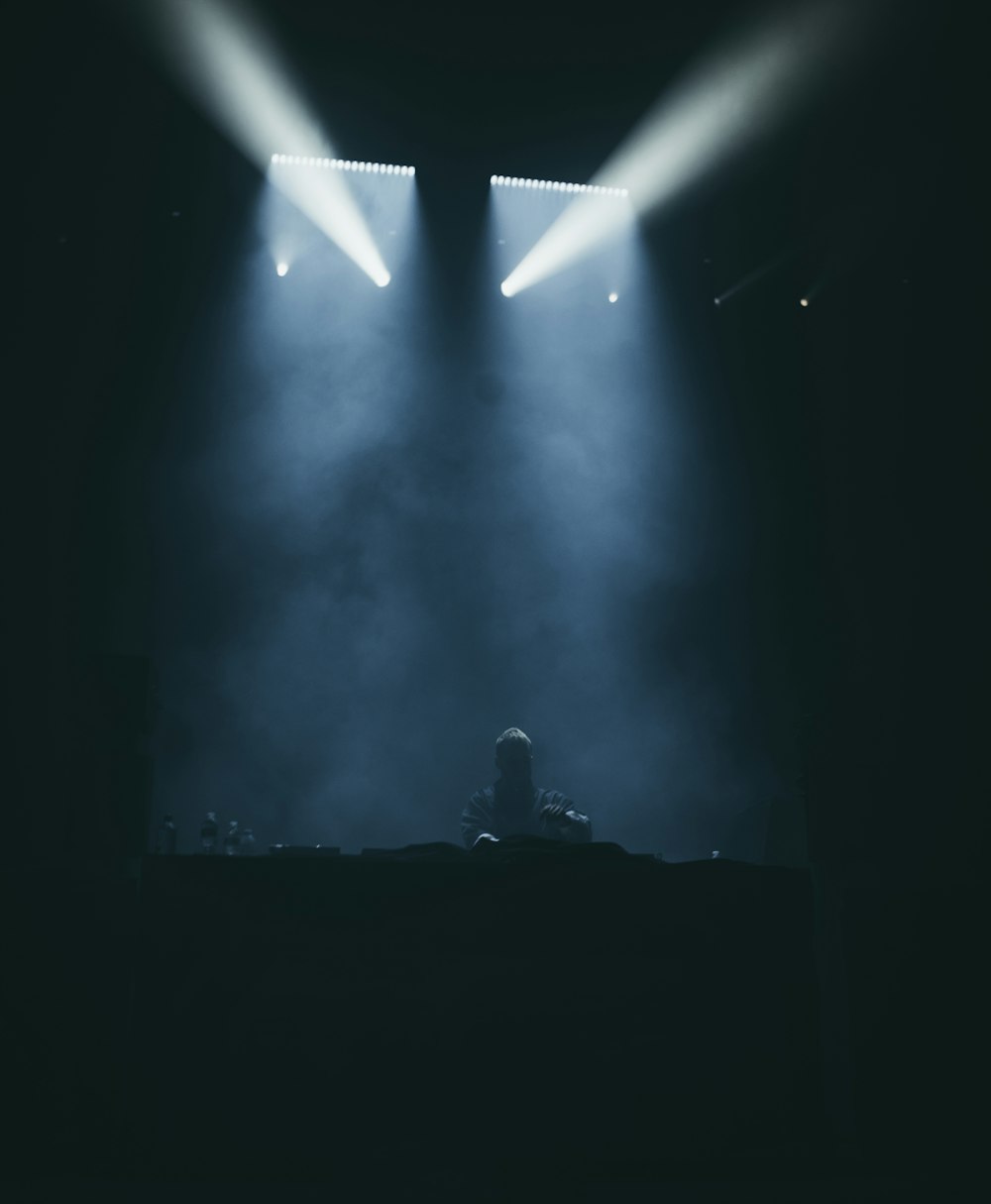 silhouette photography of person under track lights