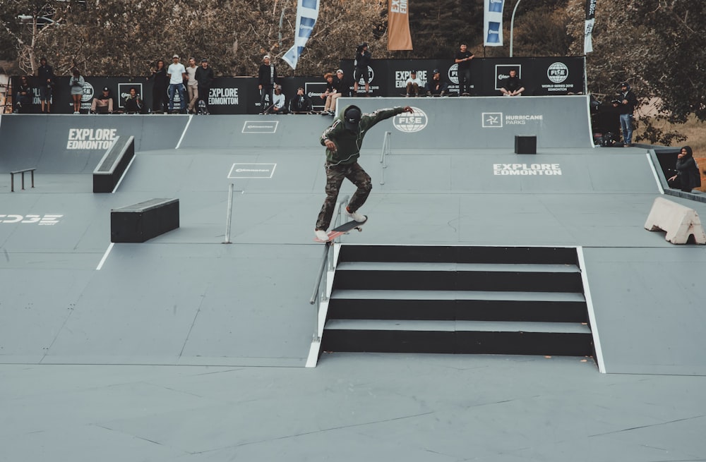 person skidding skateboard on rail