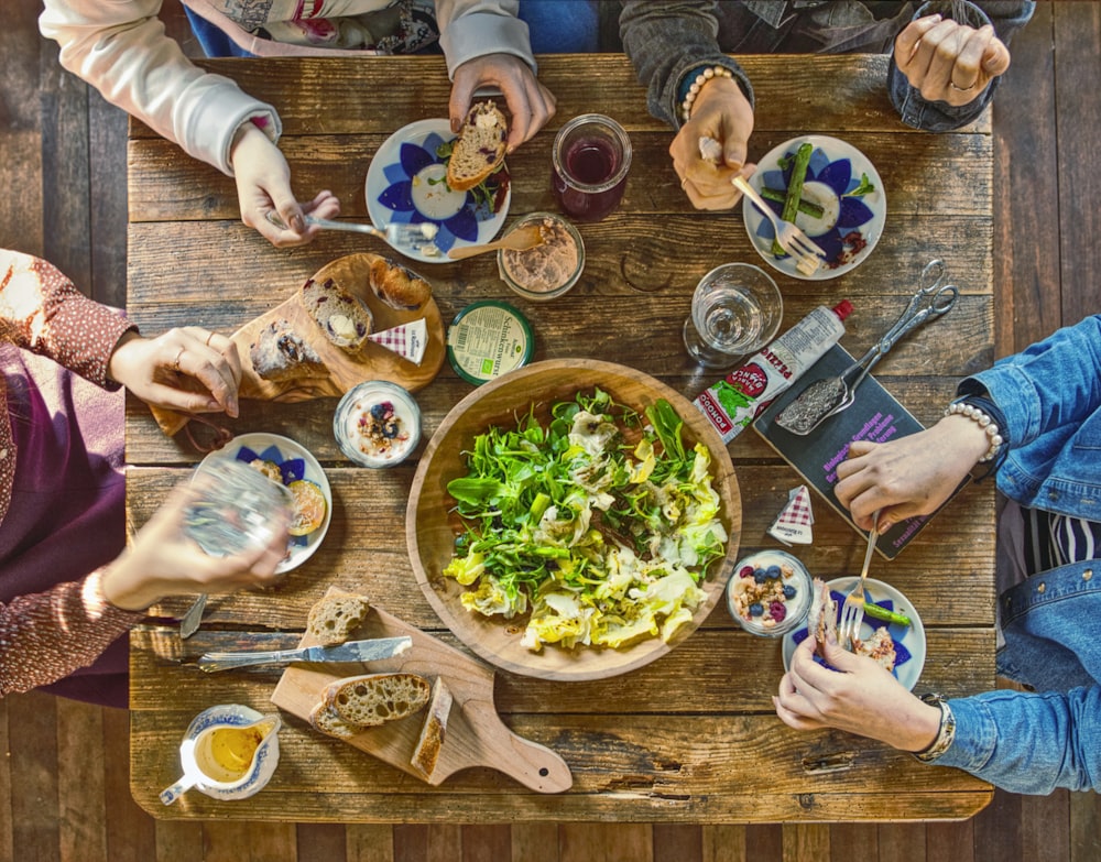 people eating on brown wooden table