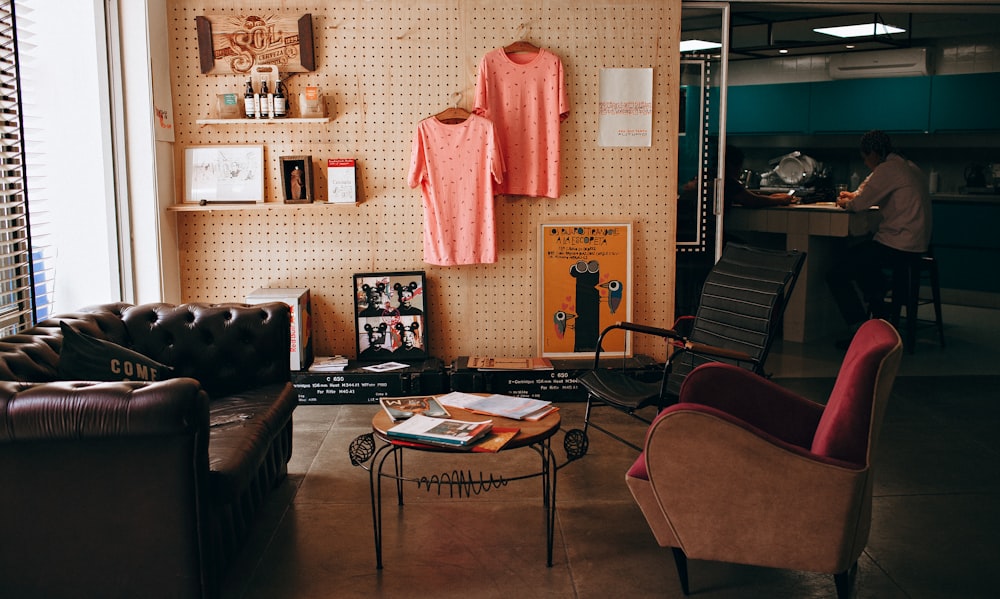 two pink shirts hanging on wall