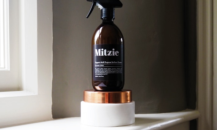 black Mitzie spray bottle near window