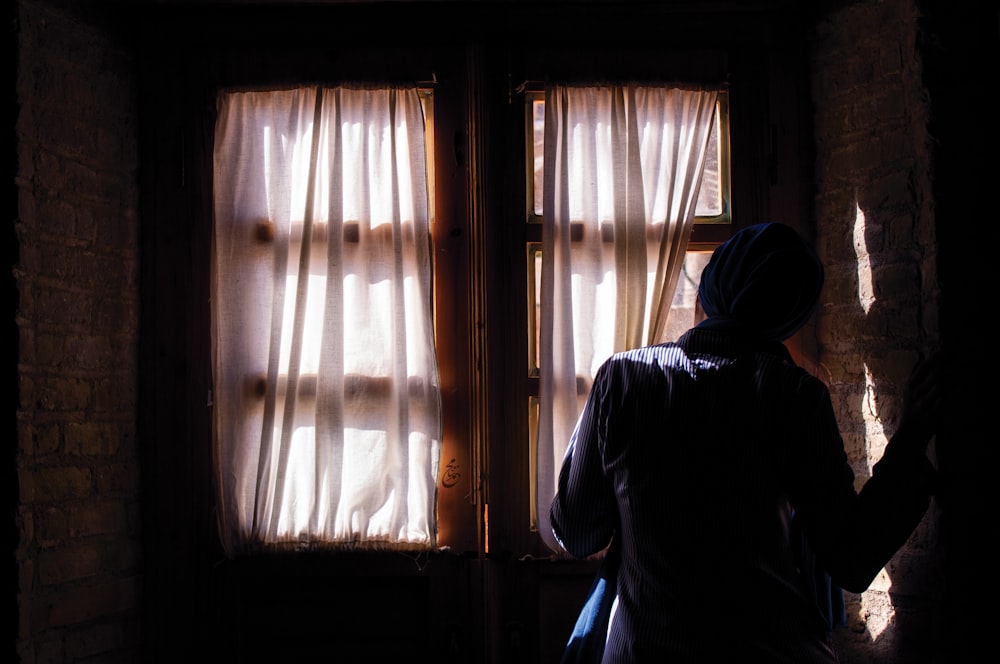 person standing in front of window