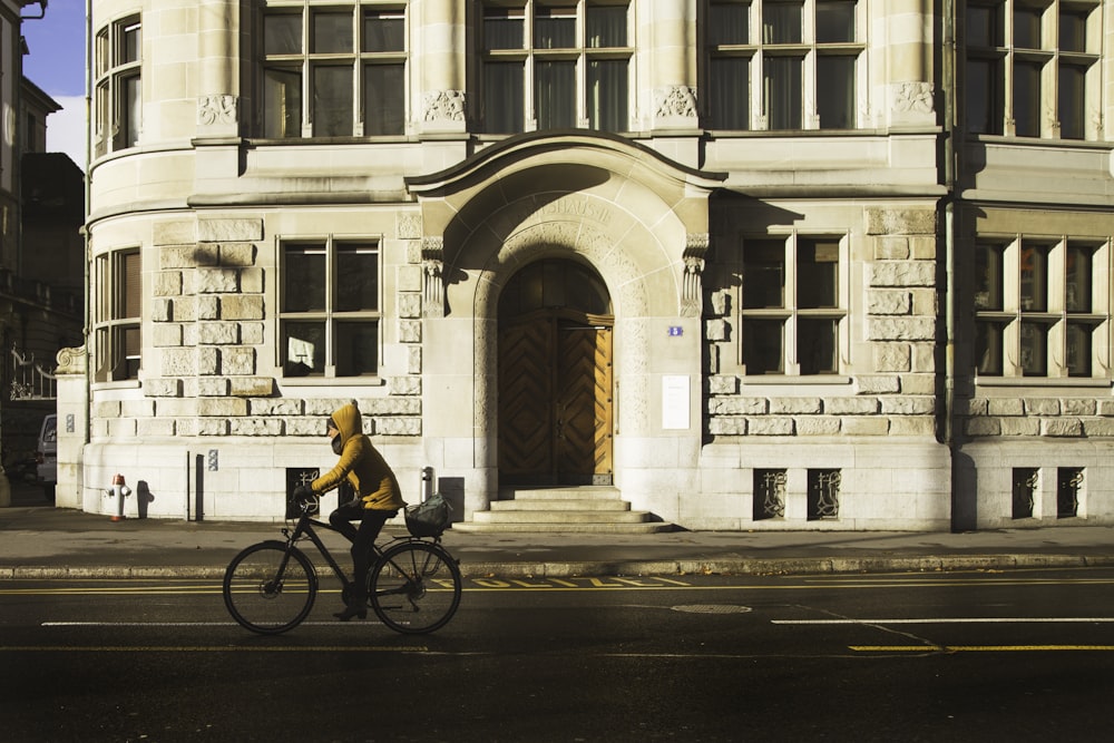 person biking on road during daytime