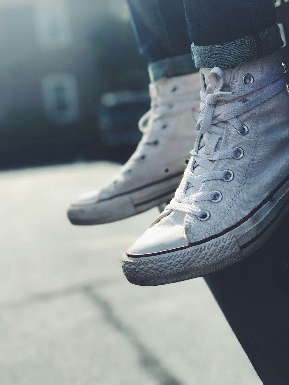 low-angle photography of person wearing white mid-high sneakers