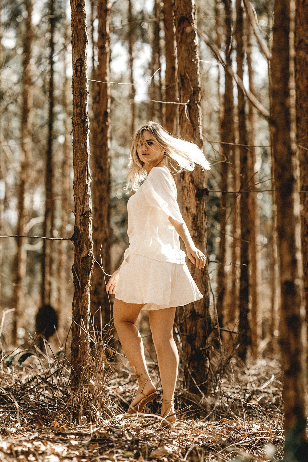 woman standing in the middle of forest