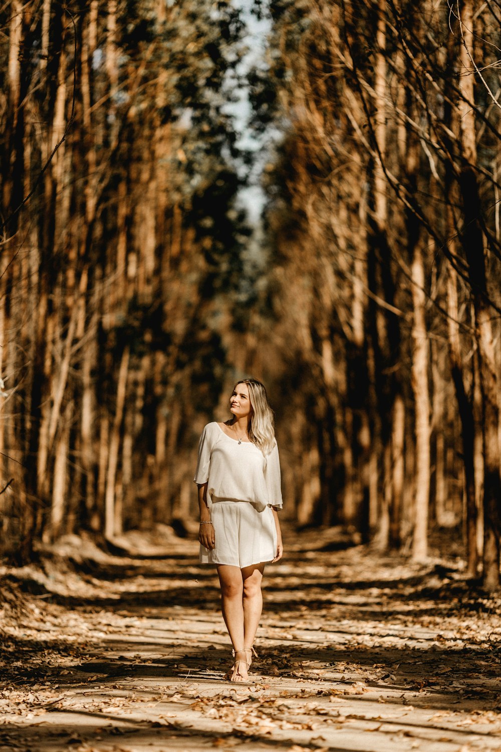 woman standing between trees