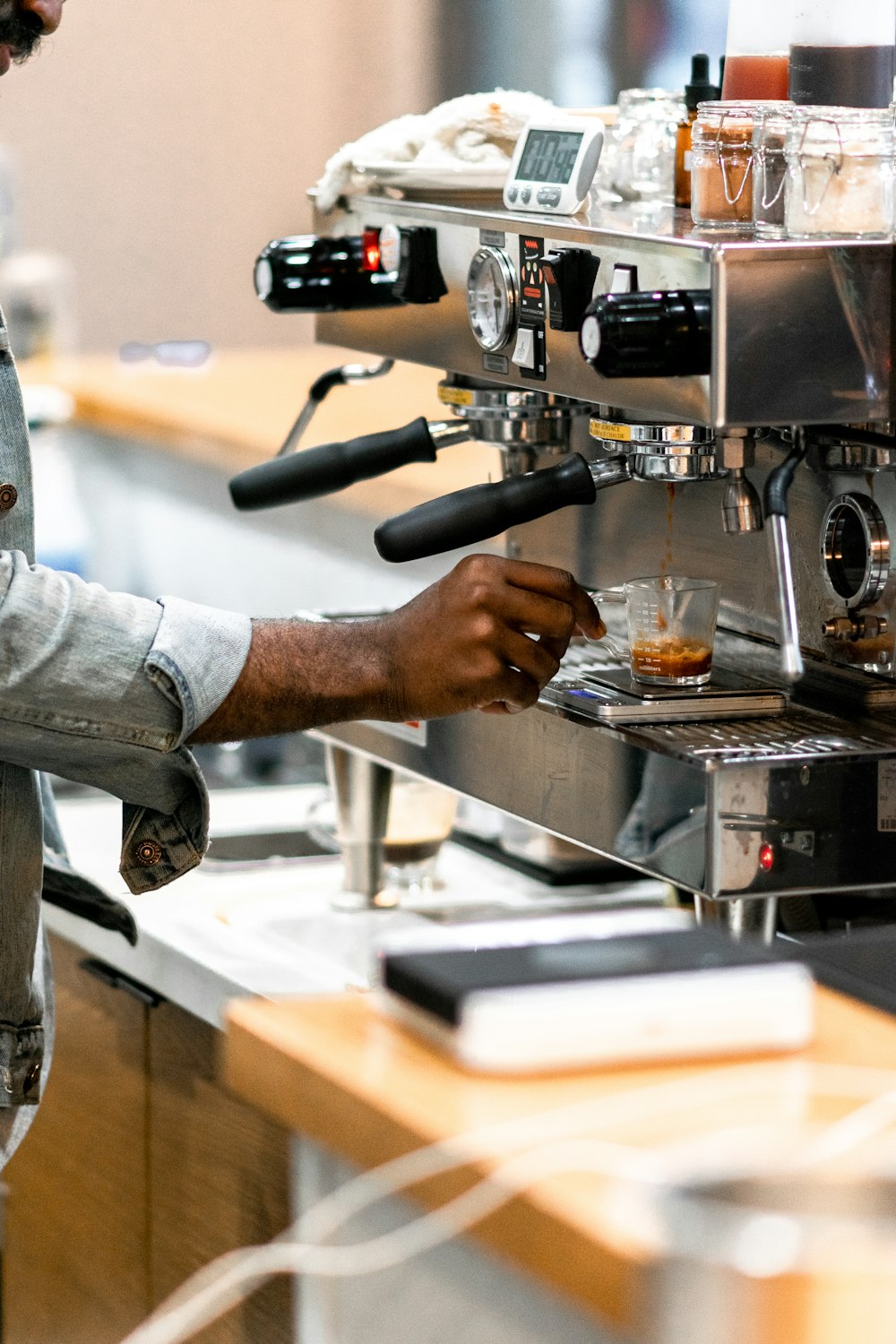 man using grey coffee machine