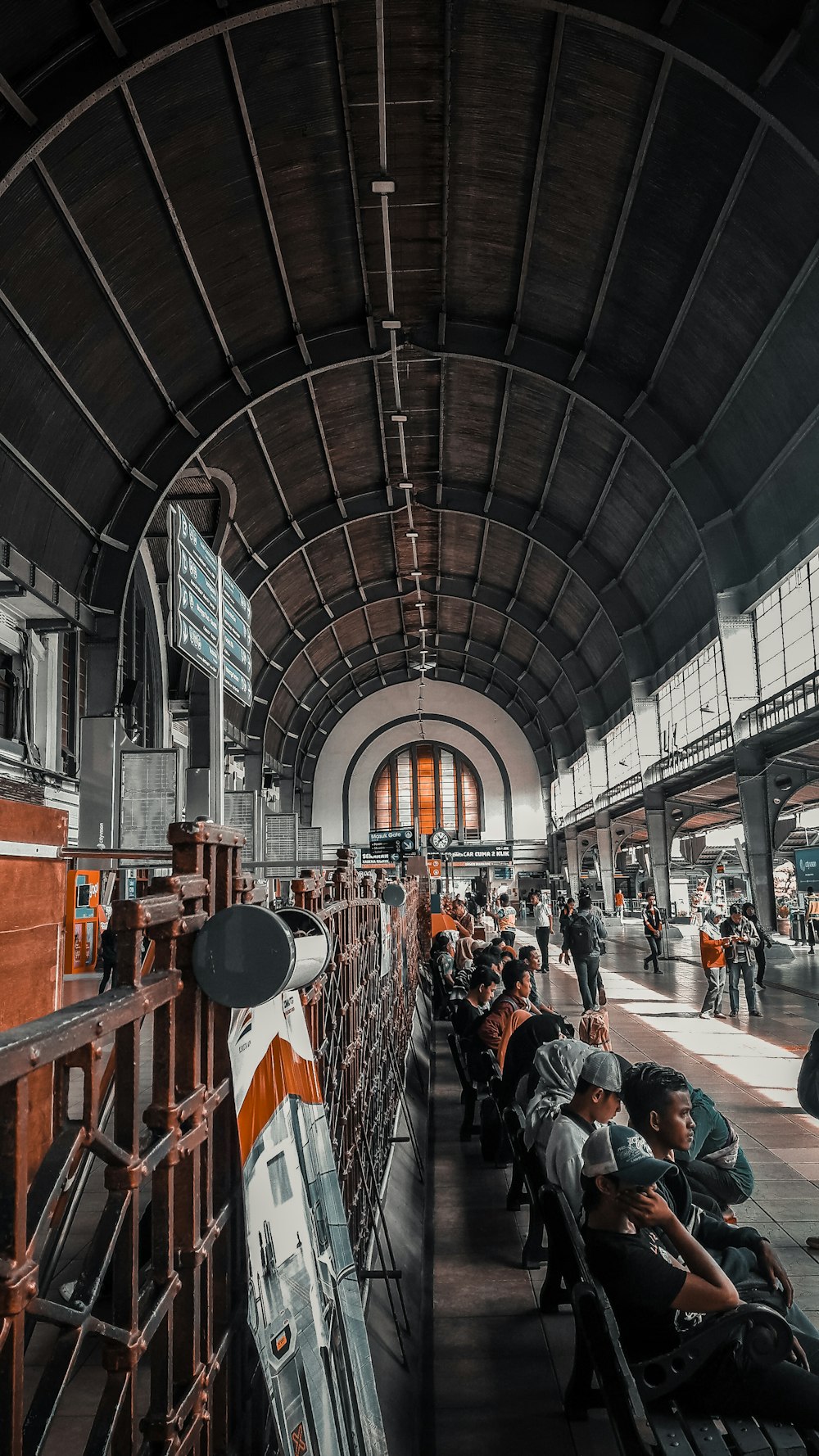 people sitting inside train station during daytime