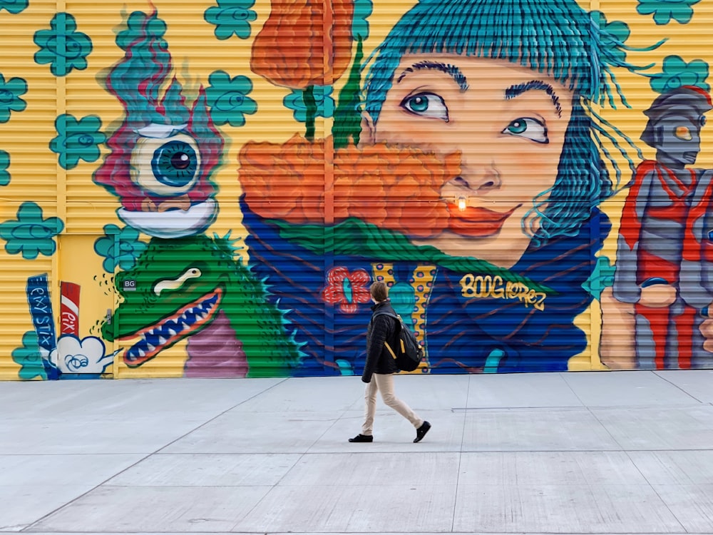 person standing in front of wall art