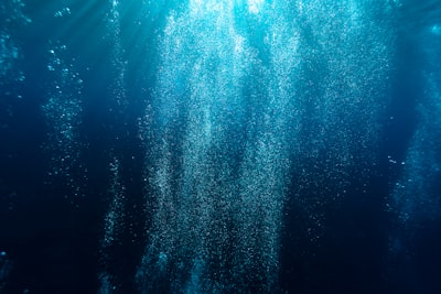 photography of blue water underwater zoom background