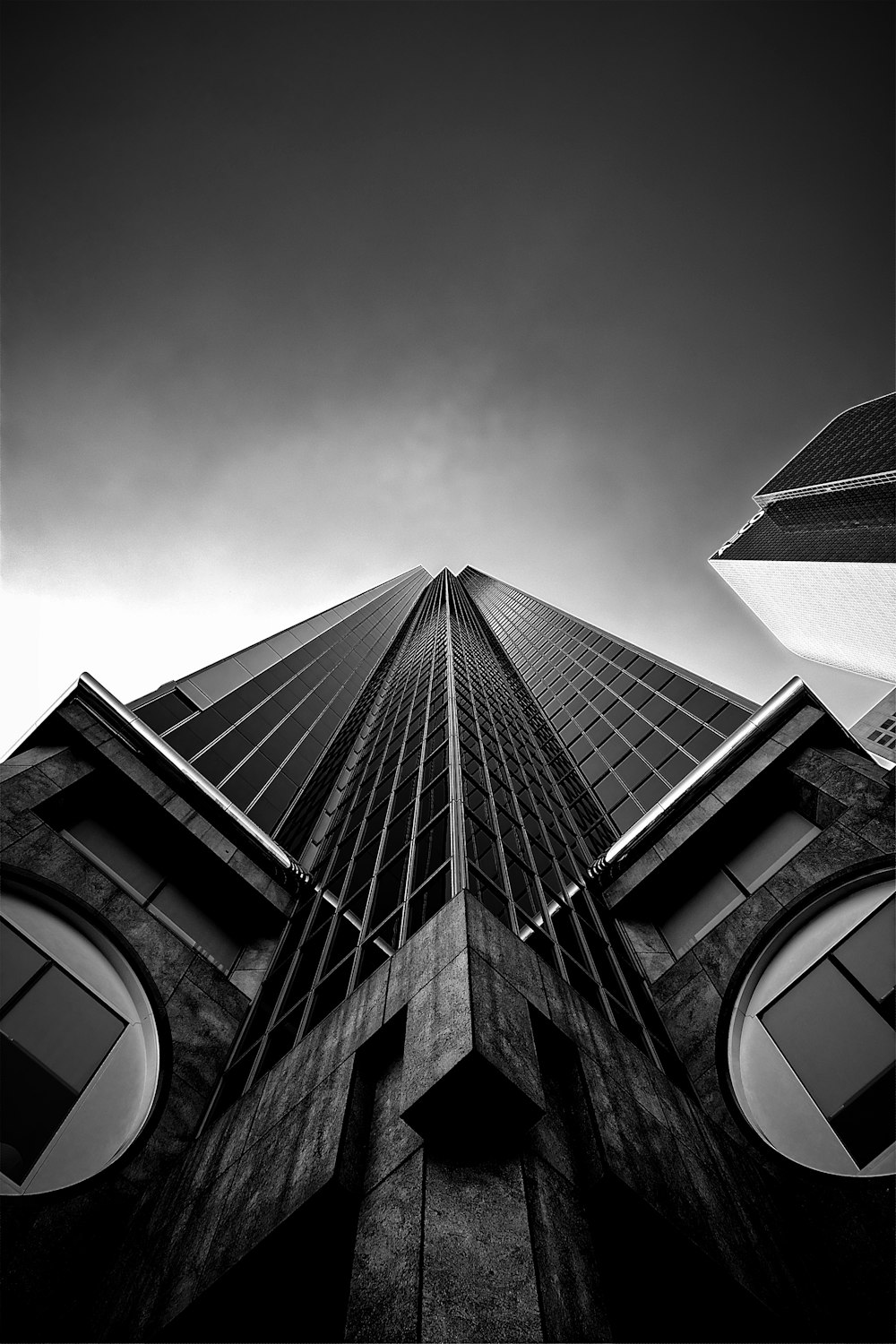 high-rise building greyscale photography