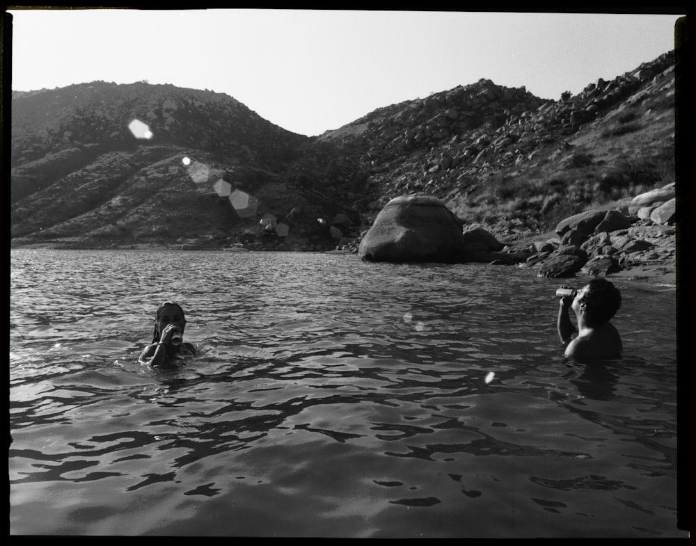 two man in body of water