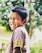 A happy child wearing colorful clothing in a bright, cheerful environment.