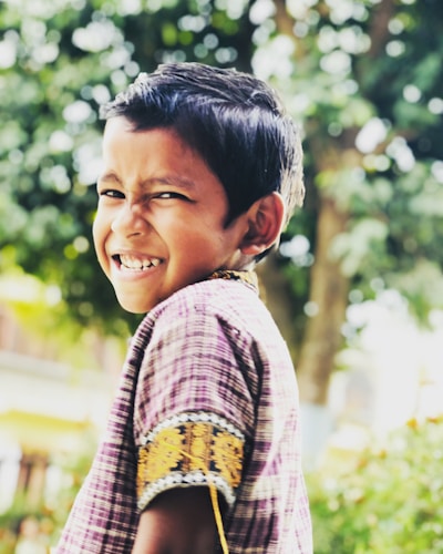 Smiling toddler wearing colorful clothes outdoors