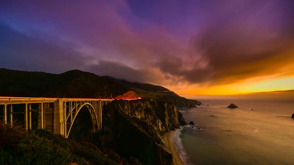 brown suspension bridge beside body of water