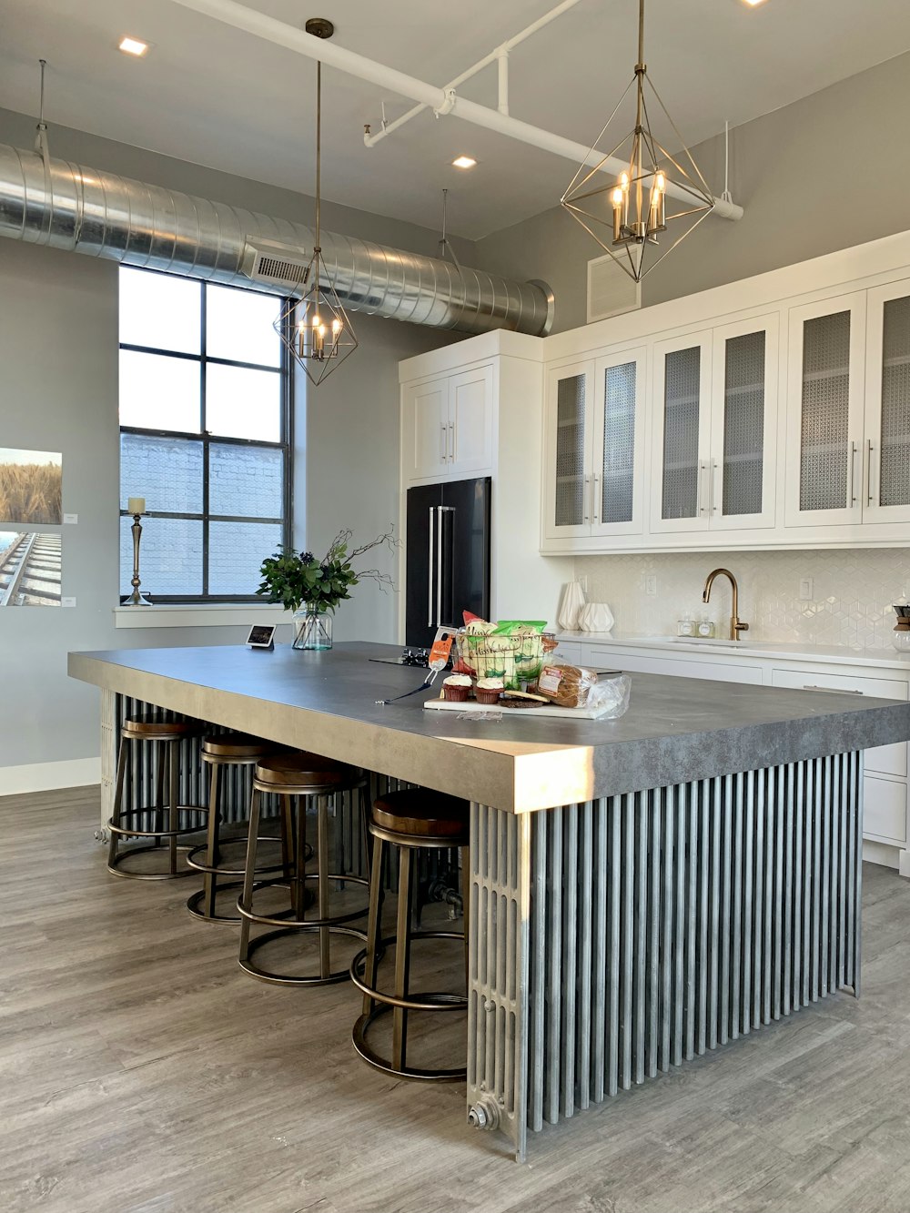 gray metal island table near white wooden kitchen cabinet