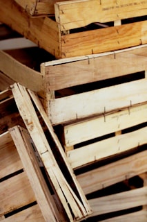 A collection of stacked, unfinished wooden crates with visible textures and grain patterns.