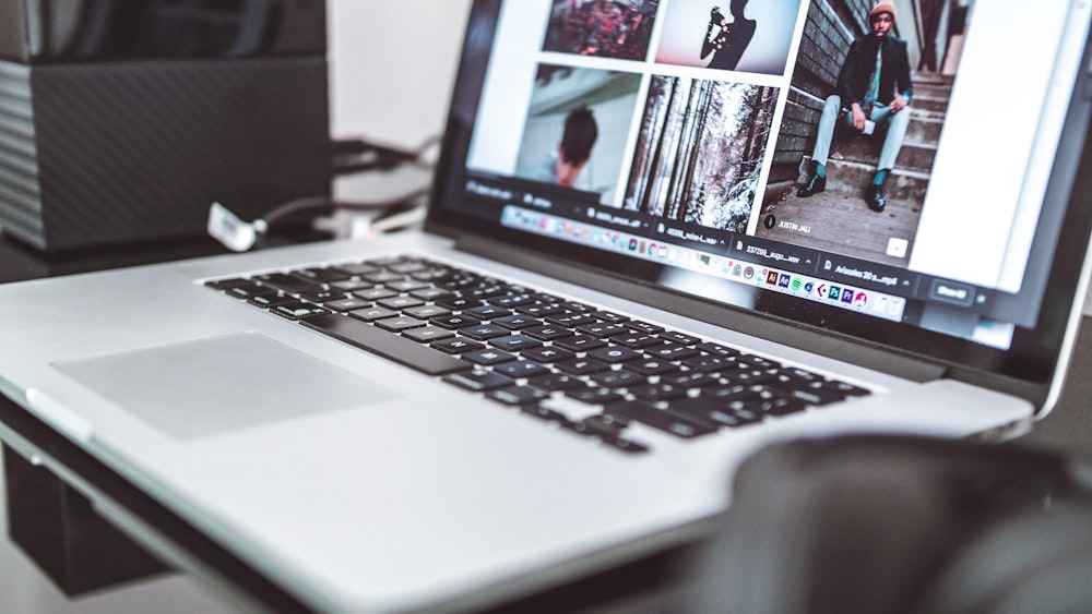 silver laptop displaying man sitting on stairs