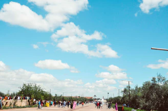 A vibrant street scene in Manus Province with locals engaging in daily activities under clear blue skies.