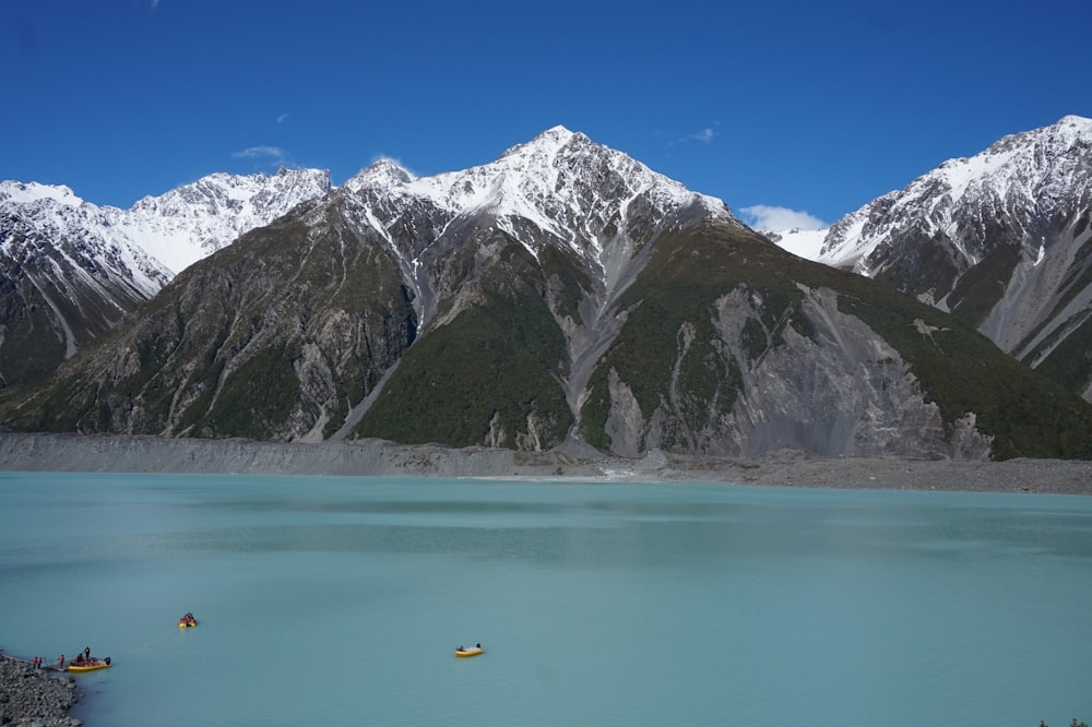 people riding on boat while crossing lake during daytime