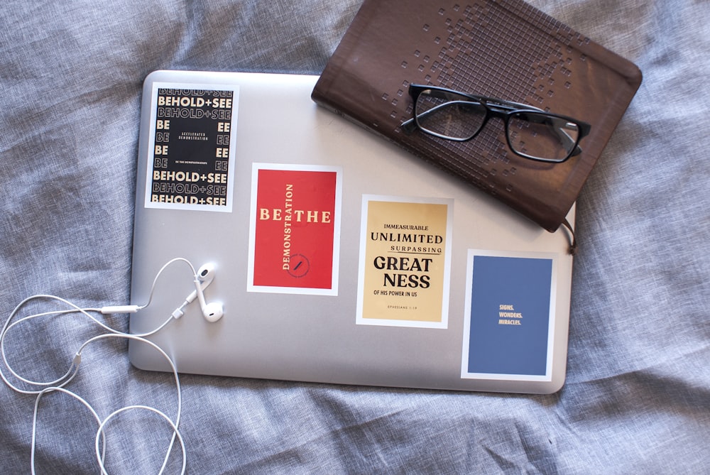 white earbuds on silver laptop