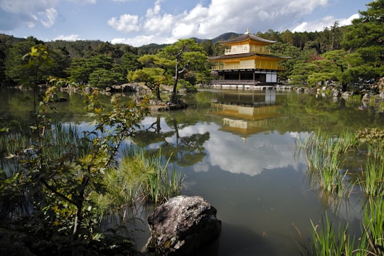 brown and gray house near lake surrounded with trees in Kinkaku-ji Japan