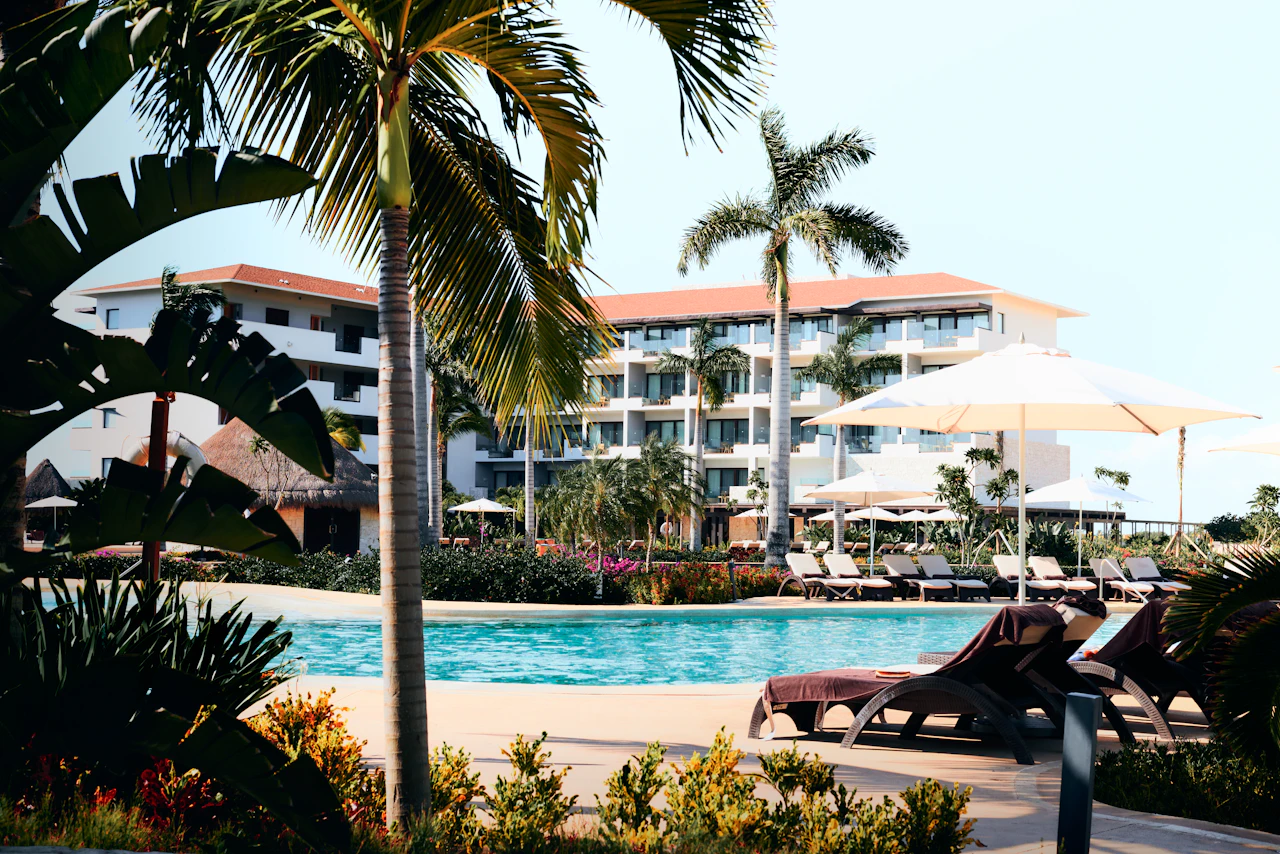 Luxury resort infinity pool at sunset with Caribbean ocean view