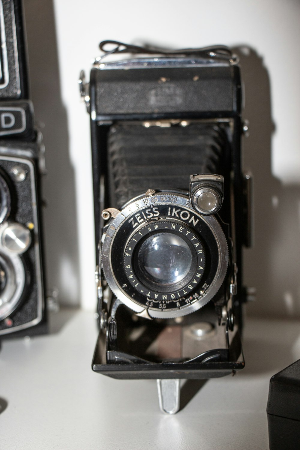 selective focus photography of black folding camera