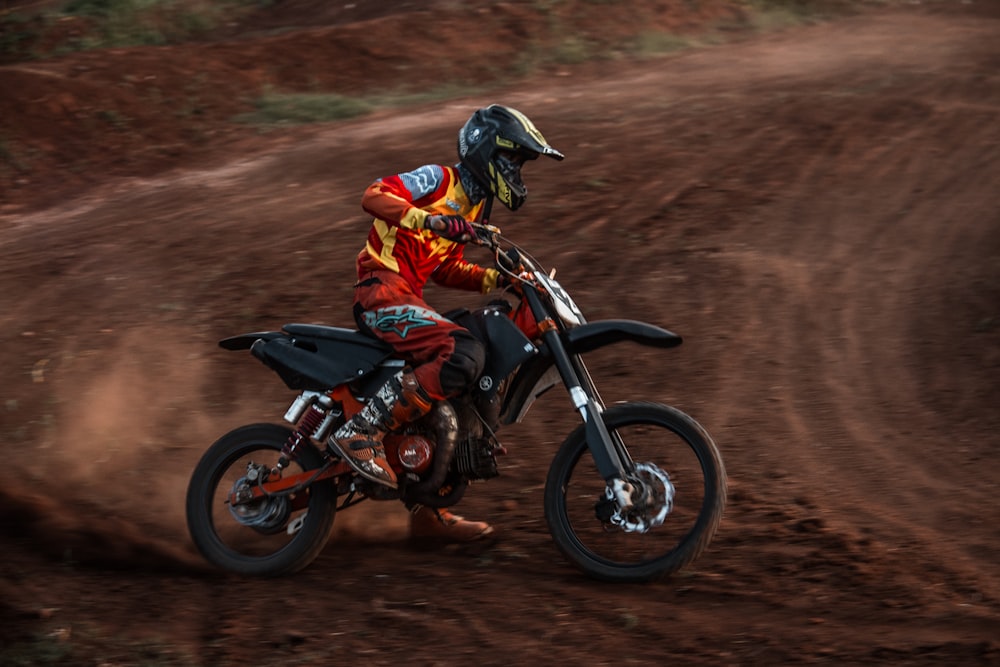 biker on dirt road during daytime