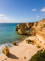 A serene view of the turquoise waters and limestone cliffs of Langkawi Island at sunset.