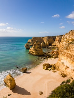 A serene beach scene in Langkawi with crystal clear waters and soft white sand.