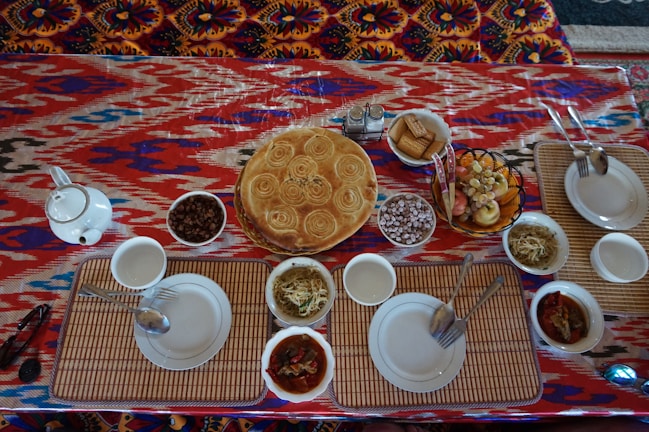 A beautifully arranged table with various colorful dishes.
