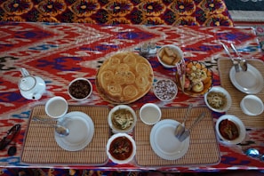 A beautifully arranged table with various colorful dishes.