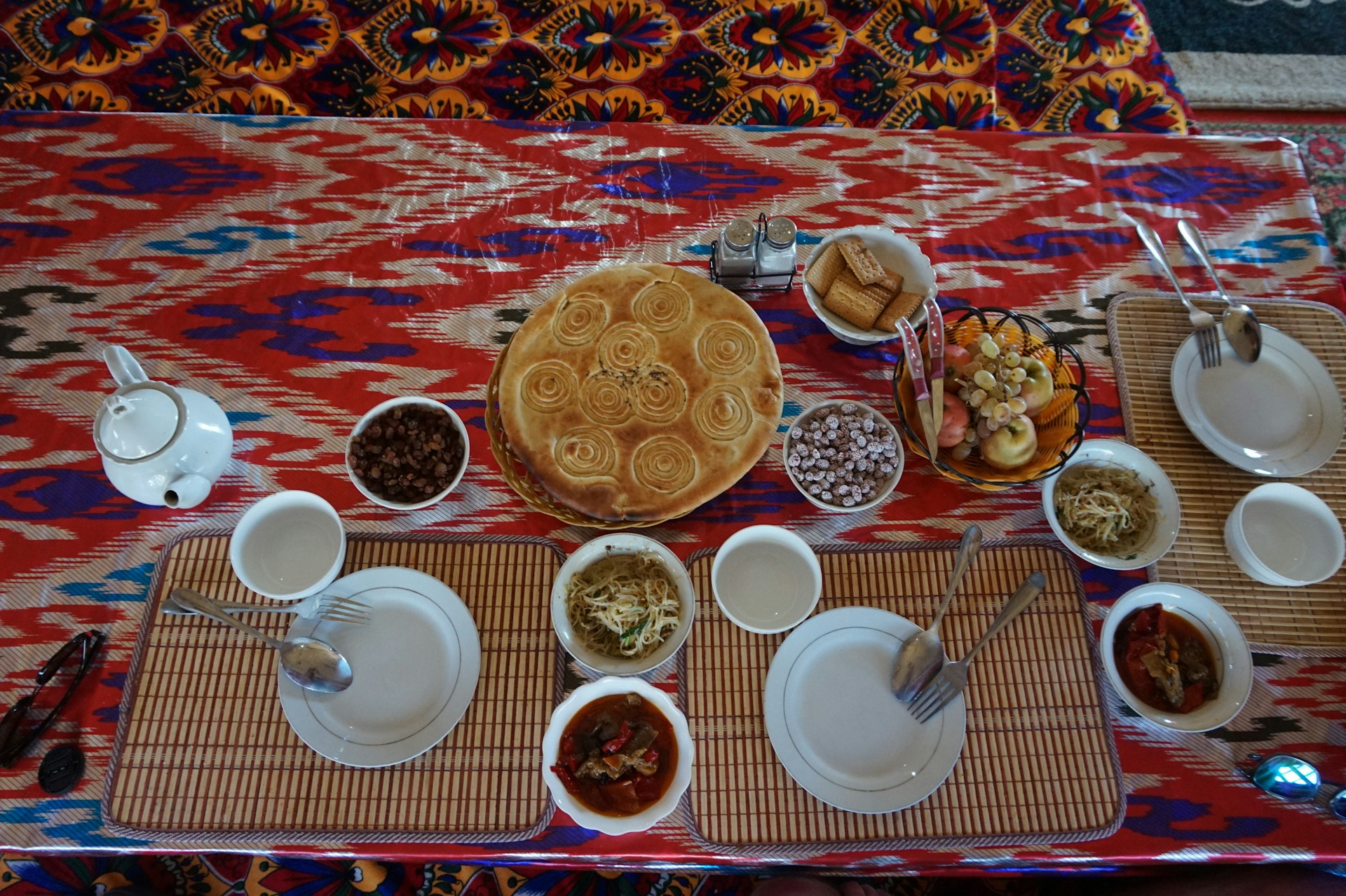 A rustic wooden table set with traditional Palestinian dishes, showcasing vibrant colors and textures.