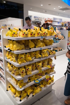 Arrangement showing Pokémon and One Piece booster boxes side by side reflecting the store's distinct categories