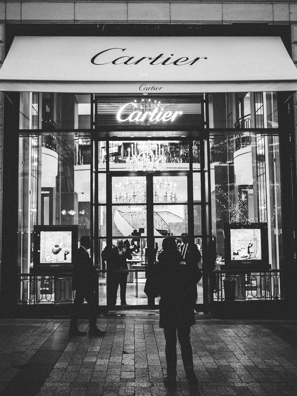 Person Standing Front Of Cartier Signage Photo Free Grey Image On Unsplash