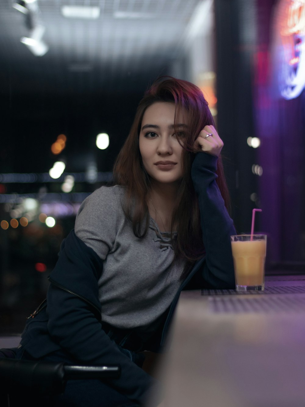 woman in black jacket leaning on table