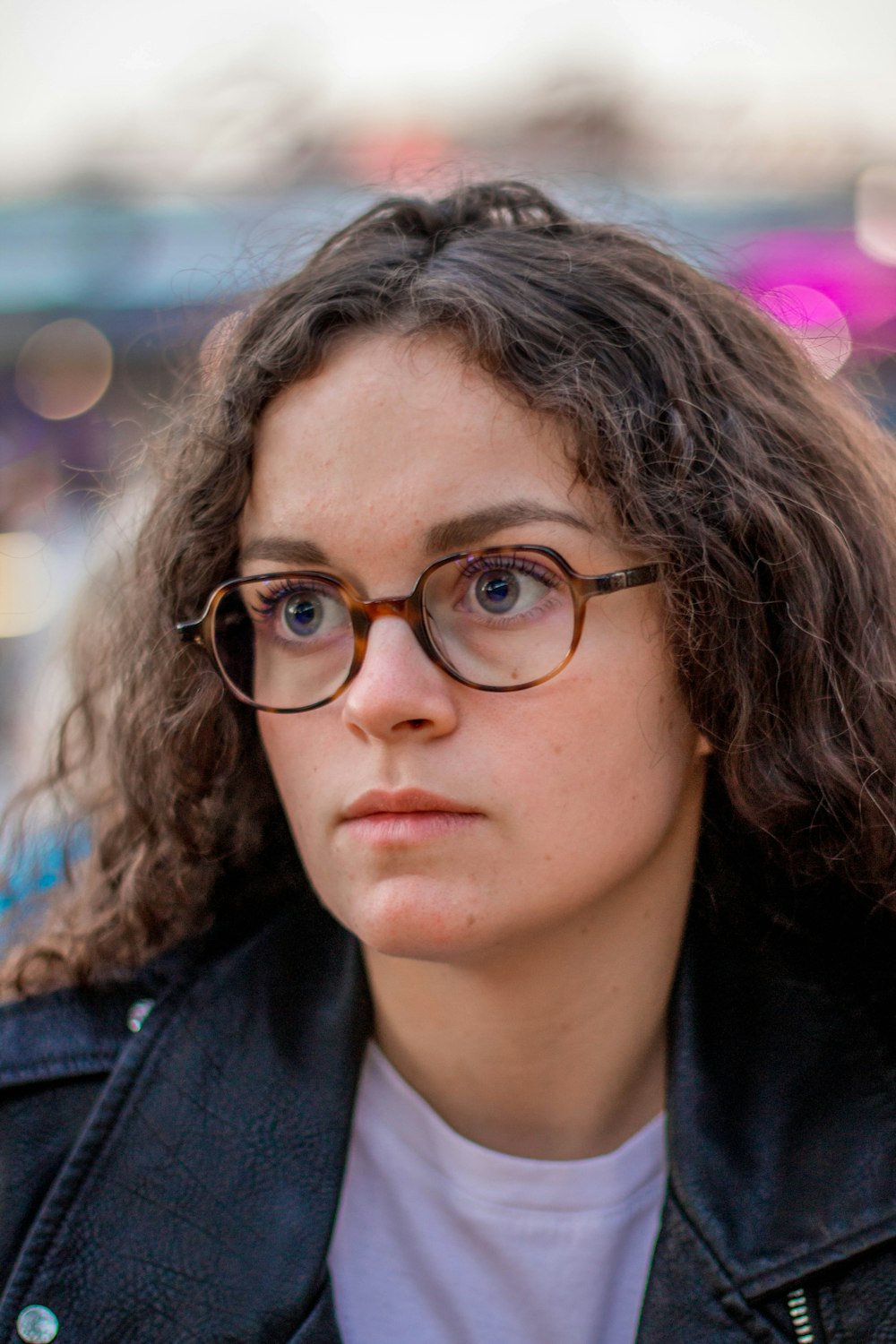 woman wearing brown framed eyeglasses with bokeh lights background