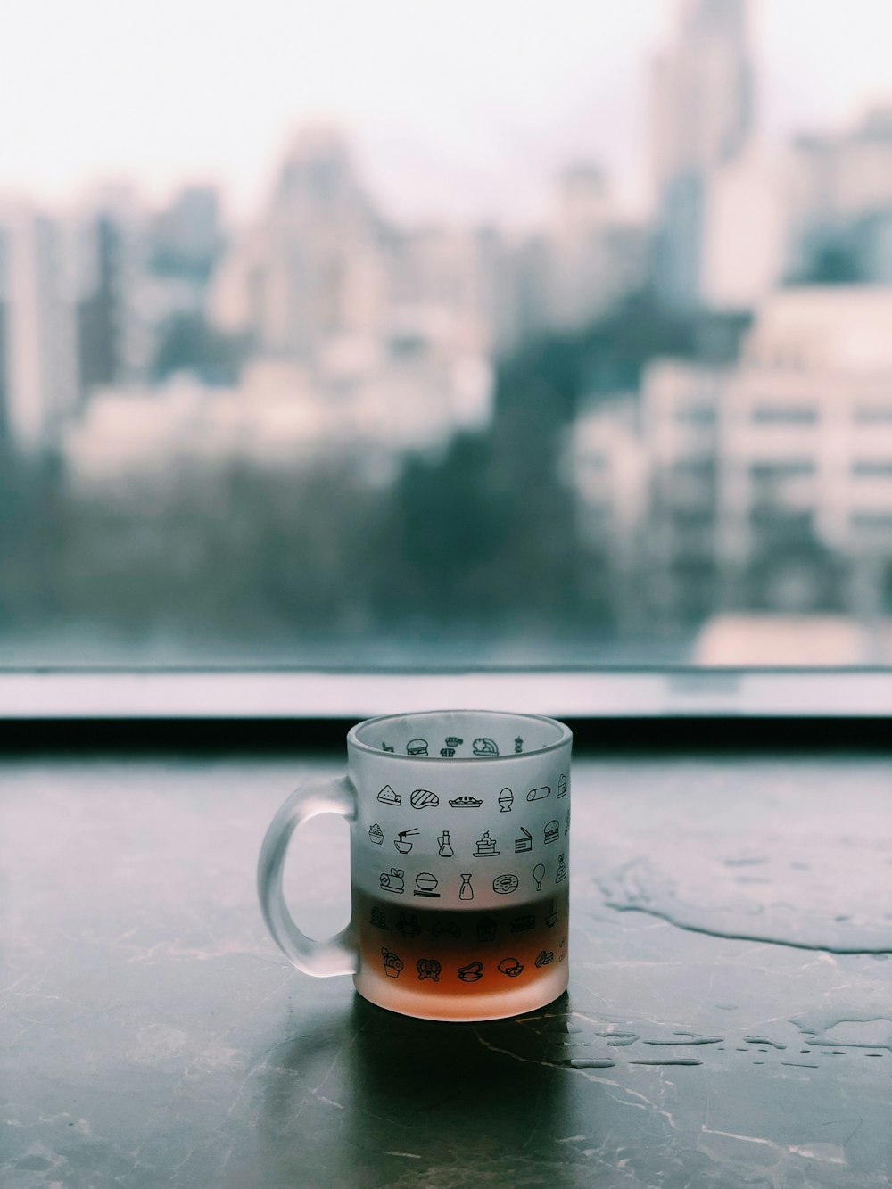 clear glass mug beside window