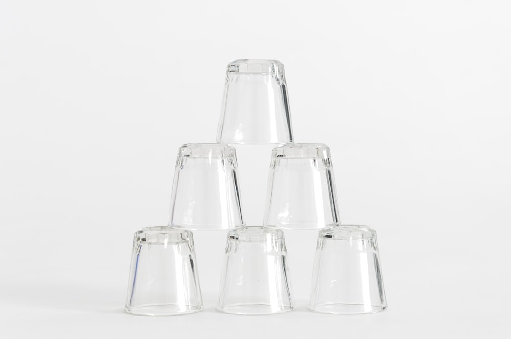 six piled clear shot glasses