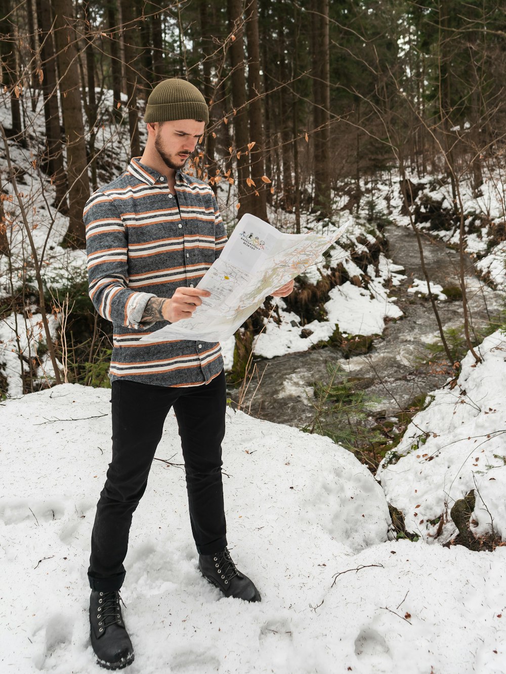 man standing holding white paper during daytime\