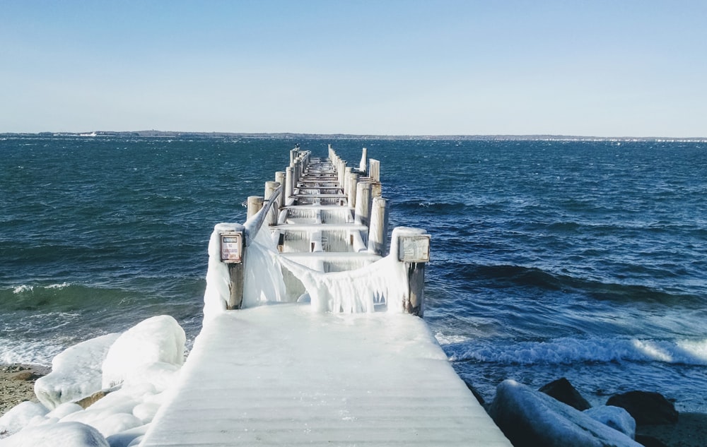 white wooden beach dock during daytime